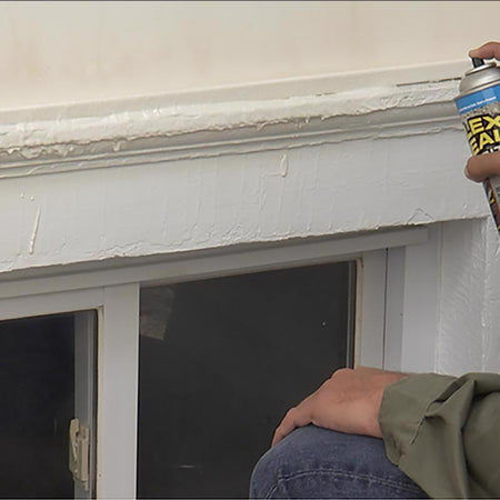 Person applying Flex Seal Brite to a window frame.