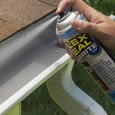 Person applying Flex Seal Brite sealant to a roof gutter.
