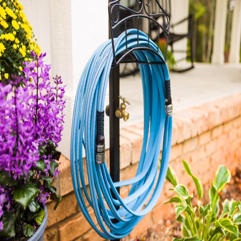 Fitt HiFlo Medium Duty Garden Hose shown on a hose holder in a garden