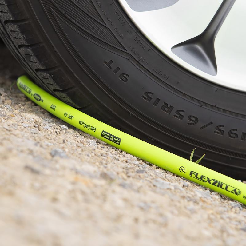 FlexZilla Flexible Hybrid Polymer Air Hose shown next to a tire.