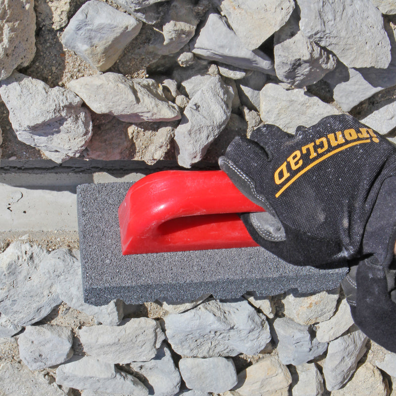 Person using the gator silicon carbide rubbing brick on mortar.