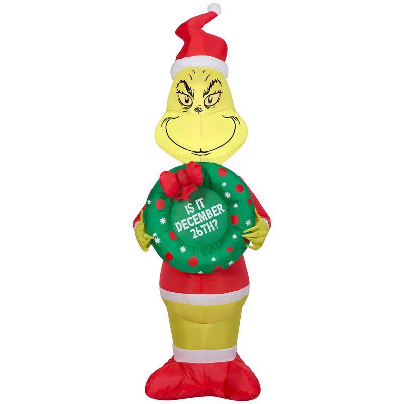Inflatable Grinch holding a wreath with text on a white background