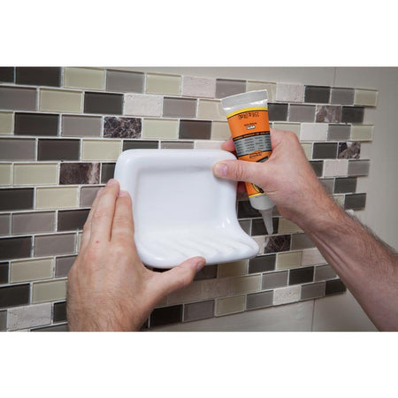 Gorilla All Purpose Construction Adhesive being applied to a soap holder.