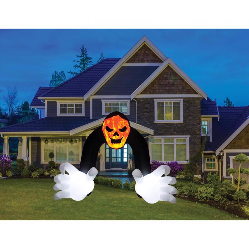 Halloween inflatable ghost with glowing face in front of a house