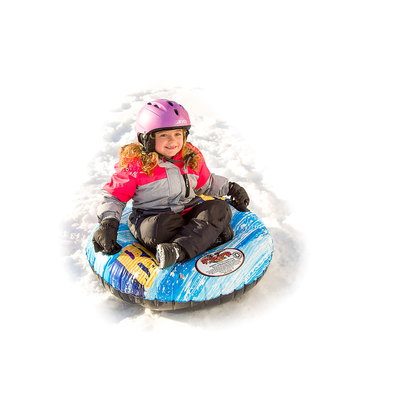 Child sitting on a blue snow tube with a helmet in the snow