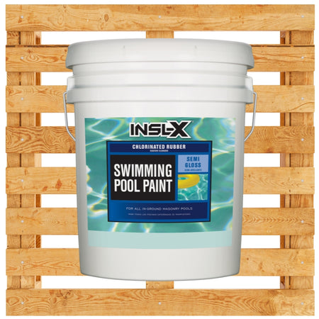 Five gallon bucket of Insl-X Chlorinated Rubber Swimming Pool paint on a wooden pallet background