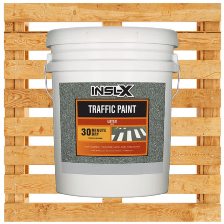 White 5 gallon bucket of INSL-X Latex Traffic Paint on a wooden pallet