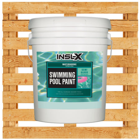 White 5 gallon pail of Insl-X Waterborne Pool Paint on a wooden pallet background