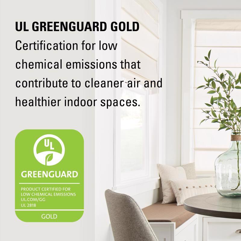 Living room with a vase of plants and text about UL Greenguard Gold certification.