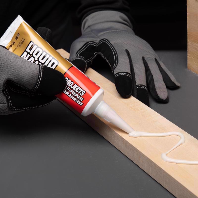 Liquid Nails Small Projects Repair Adhesive being applied to a piece of wood.
