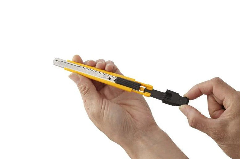 Person holding the OLFA 9mm A-1 Auto-Lock Precision Utility Knife on a white background