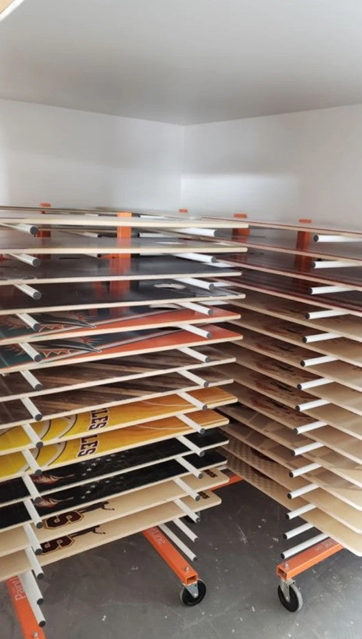 ThePaintLine PDREX Pro Drying Rack with various wooden panels in a storage room