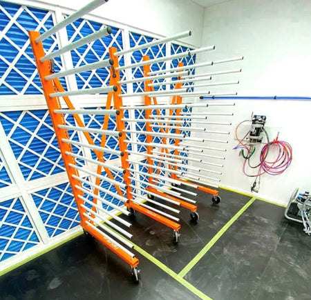 The PaintLine PDREX Pro Drying Rack against a blue geometric wall.