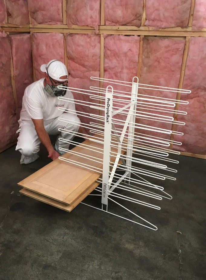 Person putting cabinet doors on the PaintLine PDRTT Drying Rack