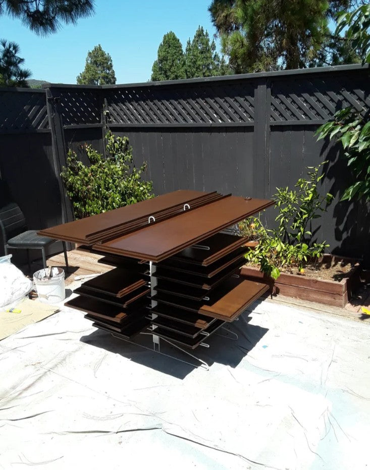 Brown wooden cabinet doors outdoors on the PaintLine PDRTT Drying Rack