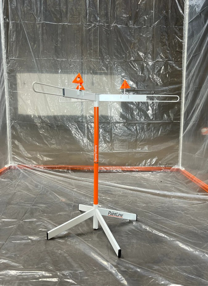 Paintline SPTY Spray Twirly Rotating Spray Table with targets on a plastic-wrapped floor