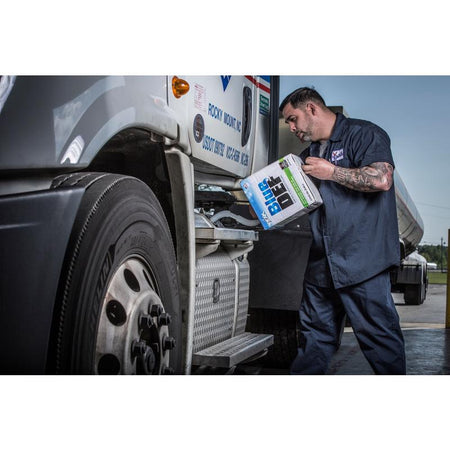 Peak Blue DEF Diesel Exhaust Fluid 2.5 Gal being poured into the tank of a truck.