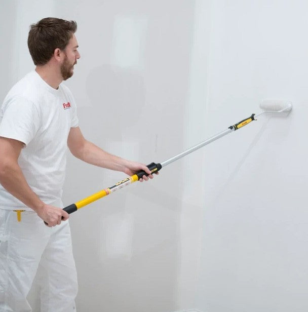 Man applying paint to a wall with the Purdy Marathon roller cover on a purdy extension pole