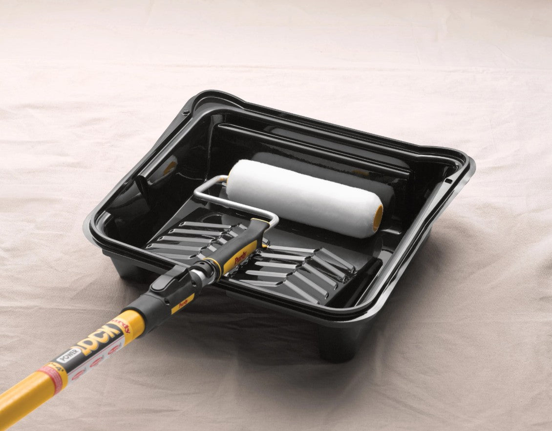 Purdy white dove roller cover on an purdy extension pole in a paint tray.