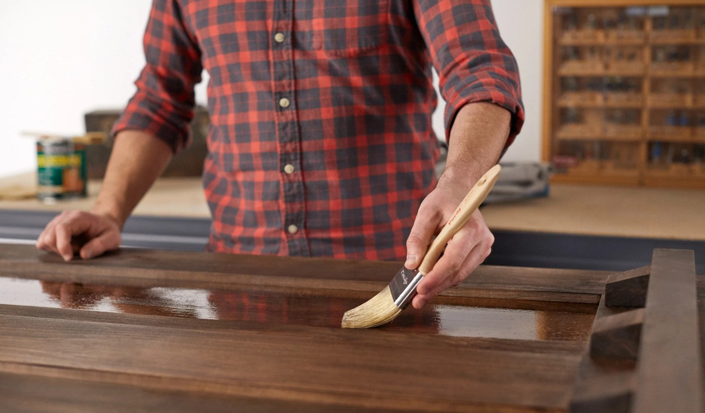 Main painting a table with Purdy White Sprig paint brush.