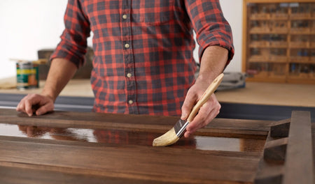 Main painting a table with Purdy White Sprig paint brush.
