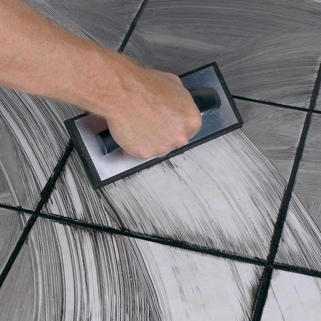QEP Molded Rubber Grout Float 10060Q being used on a tile floor