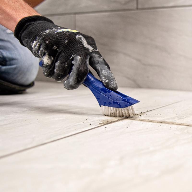 Using the QEP Grout Brush 20842 to clean grout