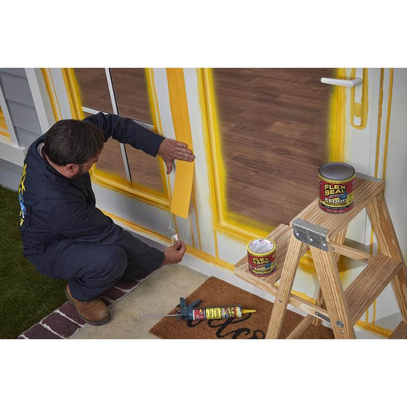 Flex Seal Flood Protection Waterproof Rubberized Tape being applied around the opening of a door.