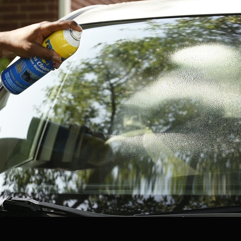 Rain-X Glass Cleaner & Rain Repellant Spray being sprayed on a windshield.
