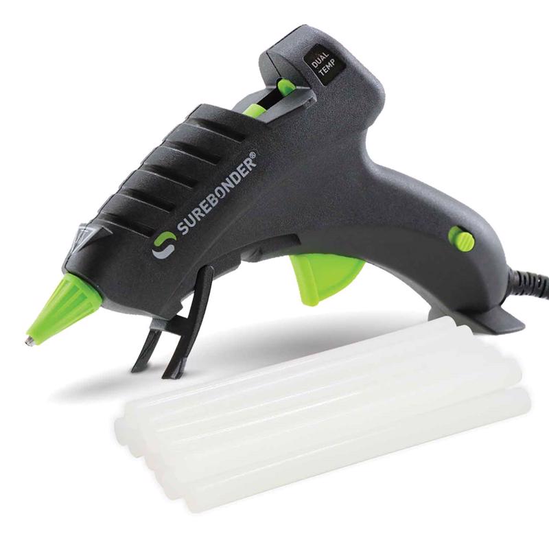 Surebonder Plus Dual Temp Mini Glue Gun Kit DT-200FKIT shown on the built in base with a pile of glue sticks on a white background.