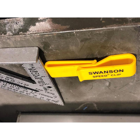 Swanson 7" Speed Square S0101-C and belt clip shown on a metal table
