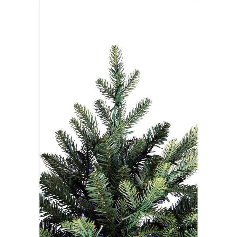 Artificial Christmas tree with green needles on a white background