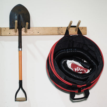 Toro Spring Bucket 29210 shown stored on a hook next to a shovel