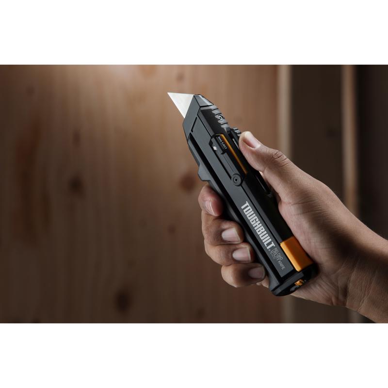 ToughBuilt Retractable Reloading Utility Knife being held in a hand.