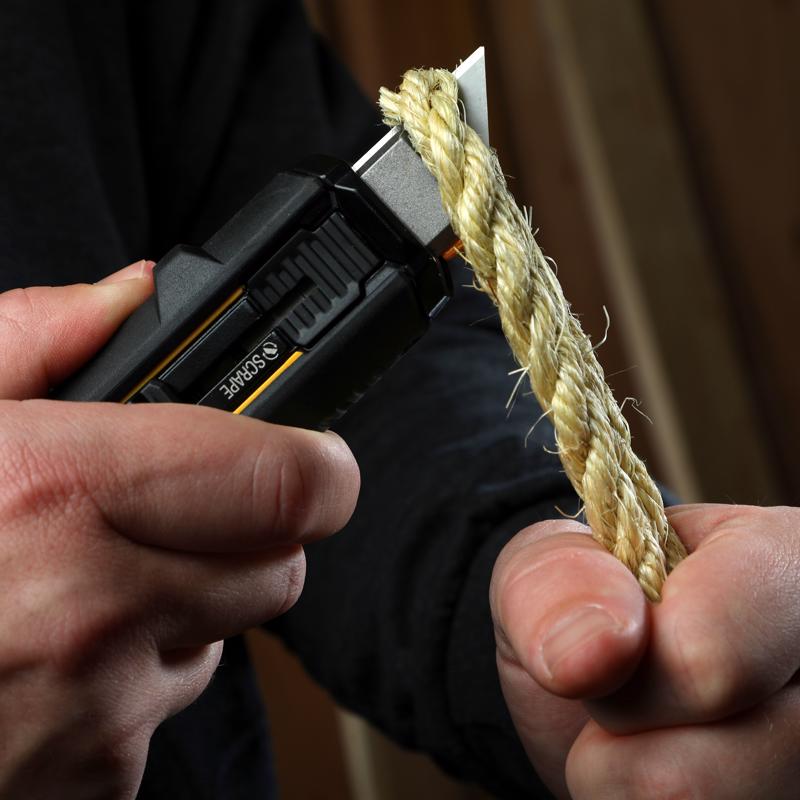 ToughBuilt Sliding Scraper Utility Knife cutting through a piece of rope.