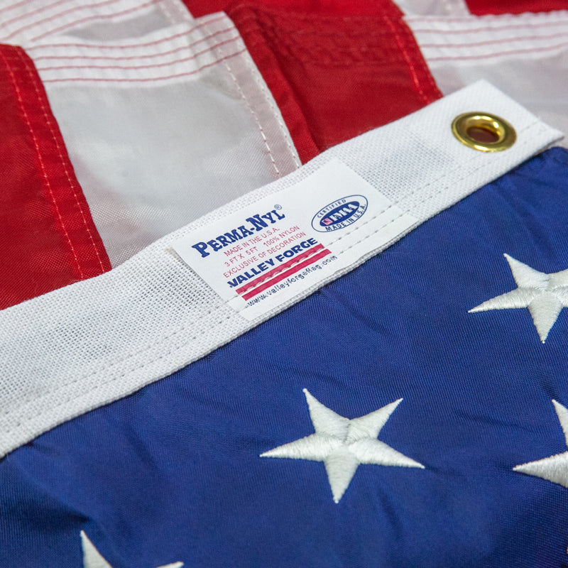 Close-up of an American flag with a Perma-Nyl label on the corner.