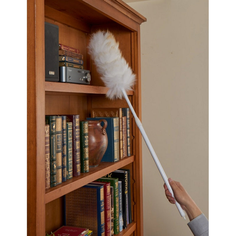 Using the Unger Extendable Wool Duster 961420 to clean a bookshelf