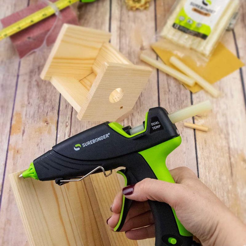 Surebonder glue gun being used on wooden blocks with SureBonder WS-12 glue sticks in the background