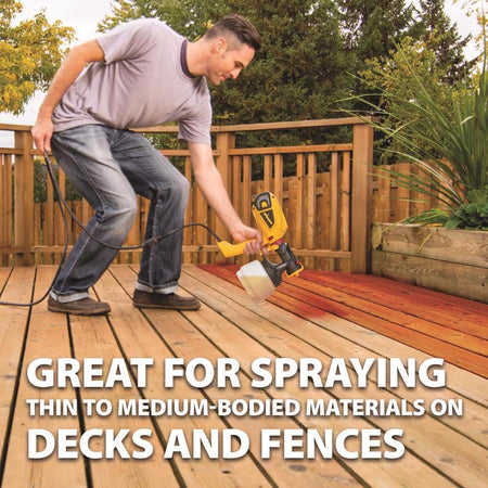 Wagner Control Spray Xtra Duty Metal HVLP Paint Sprayer being used by a man to spray stain on a deck.