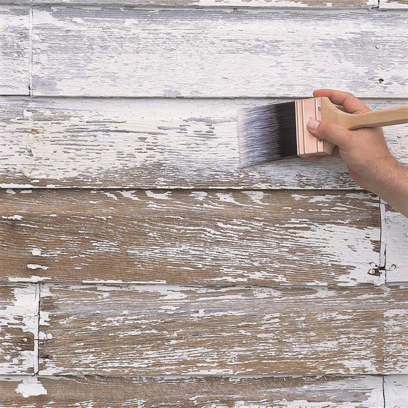 Applying Zinsser Peel Stop Primer to exterior siding with a brush.